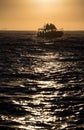 Silhouette of Speed boat in the ocean at sunrise. Royalty Free Stock Photo