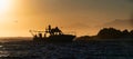 Silhouette of Speed boat in the ocean at sunrise. Royalty Free Stock Photo