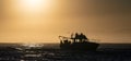 Silhouette of Speed boat in the ocean at sunrise. Royalty Free Stock Photo