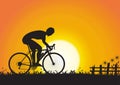 Silhouette of sport man cycling on golden sunrise background