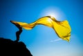 Silhouette of the sports girl with yellow fabric