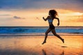 Silhouette of sporty girl running by beach sea surf pool