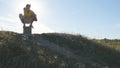 Silhouette of sporty man sitting at yoga pose outdoor. Yogi practicing yoga moves and positions in nature. Athlete