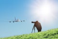 Silhouette of spotter photographer capturing photos of landing airliner Royalty Free Stock Photo