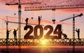 Silhouette Staff Works As A To Prepare To Welcome The New Year 2024. Construction Team Sets Numbers For New Year 2024. Large