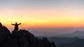 Silhouette of a standing man on top of a cliff mountain Royalty Free Stock Photo