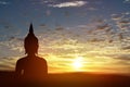 Silhouette statue of Buddha at sunset background