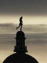 Silhouette of Statue of  Mercury/Hermes at the top of the dome of building Royalty Free Stock Photo