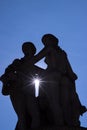 Silhouette of statue of three graces and sunshine