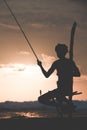 Silhouette of stilt fisherman at sunset in Koggala, Sri Lanka Royalty Free Stock Photo