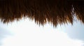Silhouette of straw thatched roof with cloudy sky background Royalty Free Stock Photo