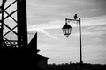 Silhouette of the street lamp and the sitting bird. Black and white photography. Royalty Free Stock Photo