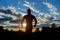 Silhouette of a strong muscular man on a background of sunset sky. Royalty Free Stock Photo