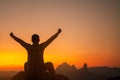 Silhouette of success man hiker outstretched arms on top of the mountain with beautiful sunset.Concept of adventure travel Royalty Free Stock Photo