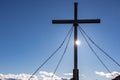 Silhouette of summit cross of mountain peak Zingerle Kreuz, Saualpe, Lavanttal Alps, Carinthia. Sun star photography Royalty Free Stock Photo