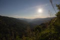 Silhouette sun and range of mountain at tropical rain forest in