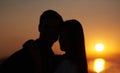 Silhouette, sunset and couple hug outdoor with view of nature, travel and bonding for love and commitment. People in Royalty Free Stock Photo