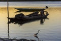 Silhouette at sunset of a fisherman in his canoe docked on the grandiose Paraguacu river