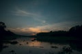 Silhouette sunset landscape over a kalindri river of malda with orange and blue sky