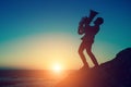 Silhouette at sunset of a musician play Tuba musical instrument on sea shore outdoor. Hobby. Royalty Free Stock Photo