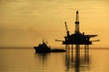 Silhouette of supply vessel and drilling platform Royalty Free Stock Photo