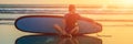 Silhouette of surf man sitting with a surfboard on the seashore beach at sunset time BANNER, long format Royalty Free Stock Photo