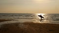 Silhouette of surf man with surfboard running on water surface. Royalty Free Stock Photo