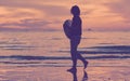 Silhouette of a surfer heading