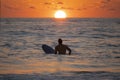 Silhouette of Surfer waiting on the line up for a wave at sunrise or sunset Royalty Free Stock Photo