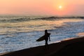 Silhouette of surfer walking at beach with sunset Royalty Free Stock Photo