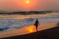 Silhouette of surfer walking at beach with sunset Royalty Free Stock Photo