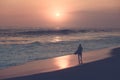 Silhouette of surfer walking at beach with sunset Royalty Free Stock Photo