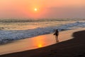 Silhouette of surfer walking at beach with sunset Royalty Free Stock Photo