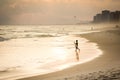 Silhouette of surfer walking on the beach during sunset Royalty Free Stock Photo