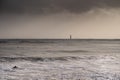 Silhouette of surfer in waves with famous Chauveau lighthouse, Royalty Free Stock Photo