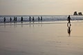 Silhouette of surfers heating up going to swim in morning sunrise