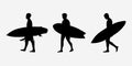 The silhouette of surfers with their boards.