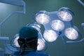 Silhouette of a surgeon with operating lights in the background Royalty Free Stock Photo