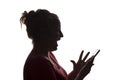 Silhouette surprise exclamation girl with mobile smart phone, using - isolated Royalty Free Stock Photo