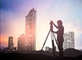 Silhouette survey engineer working in a building site over Blur