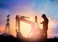 Silhouette survey engineer working in a building site over Blur