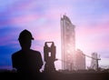 Silhouette survey engineer working in a building site over Blur