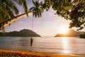 Silhouette of swing men with sunset over tropical island in background. El Nido bay. Philippines Royalty Free Stock Photo