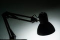 Silhouette of a table lamp on the background of a window in the morning at dawn, work until morning, work at night Royalty Free Stock Photo