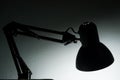 Silhouette of a table lamp on the background of a window in the morning at dawn, work until morning, work at night Royalty Free Stock Photo