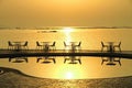 Silhouette of tables and chairs by the beach and swimming pool d