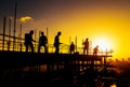 Silhouette of teamwork construction crew, building construction worker working togetherat site Royalty Free Stock Photo