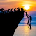 Silhouette teamwork of people climbs into cliff to reach the word Success business concept Royalty Free Stock Photo