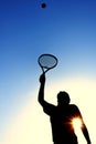 Silhouette of Teen Girl Serving a Tennis Ball Royalty Free Stock Photo