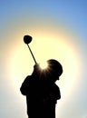 Silhouette of Teen Girl Swinging a Golf Club Royalty Free Stock Photo